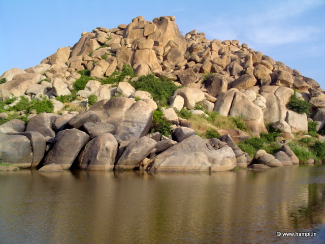 Tungabhada River makes a  bend around the boulder strewn Rishimukh Hill