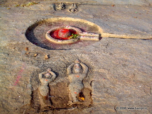 Linga with vermilion applied as mark of reverence. Also seen are images of people worshiping the Linga. Image from the Riverside Ruins site. 