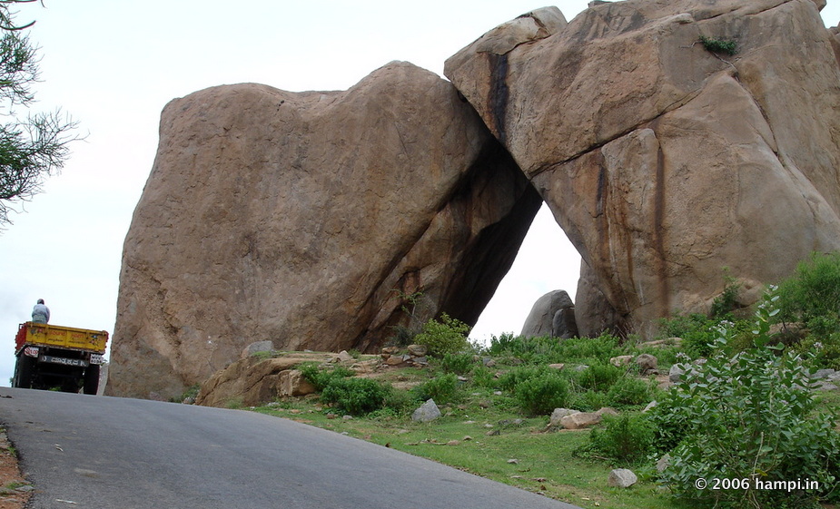Sister Boulders, locally called the 'Akka-Tangi Gudda'. 

Once this formed a natural archway on the path to Hampi. 

The photograph was taken before this leaning boulders collapsed. Note the faultline visible on the right boulder.

You can see this on the way to the Hampi village from Kamalapura. Located just after the junction where the diversion to the Underground Shiva Temple and Noble Men's Quarters are located.