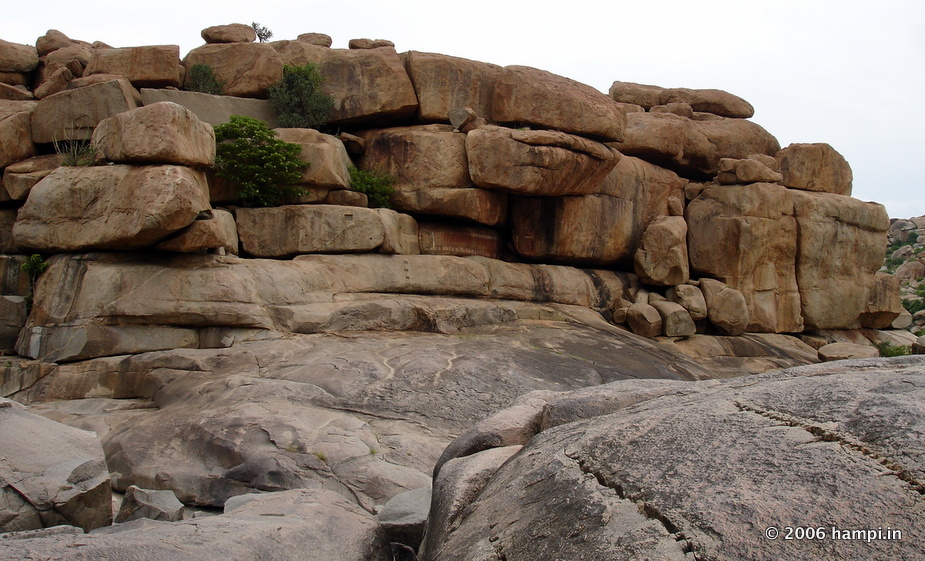 Natural  shelter formed out of boulder stacks. Located on the banks of Tungabhadra river on the way to Vittala Temple from Hampi Bazaar along the river side. Note also there is a series of Vittala Images carved on this boulder. 